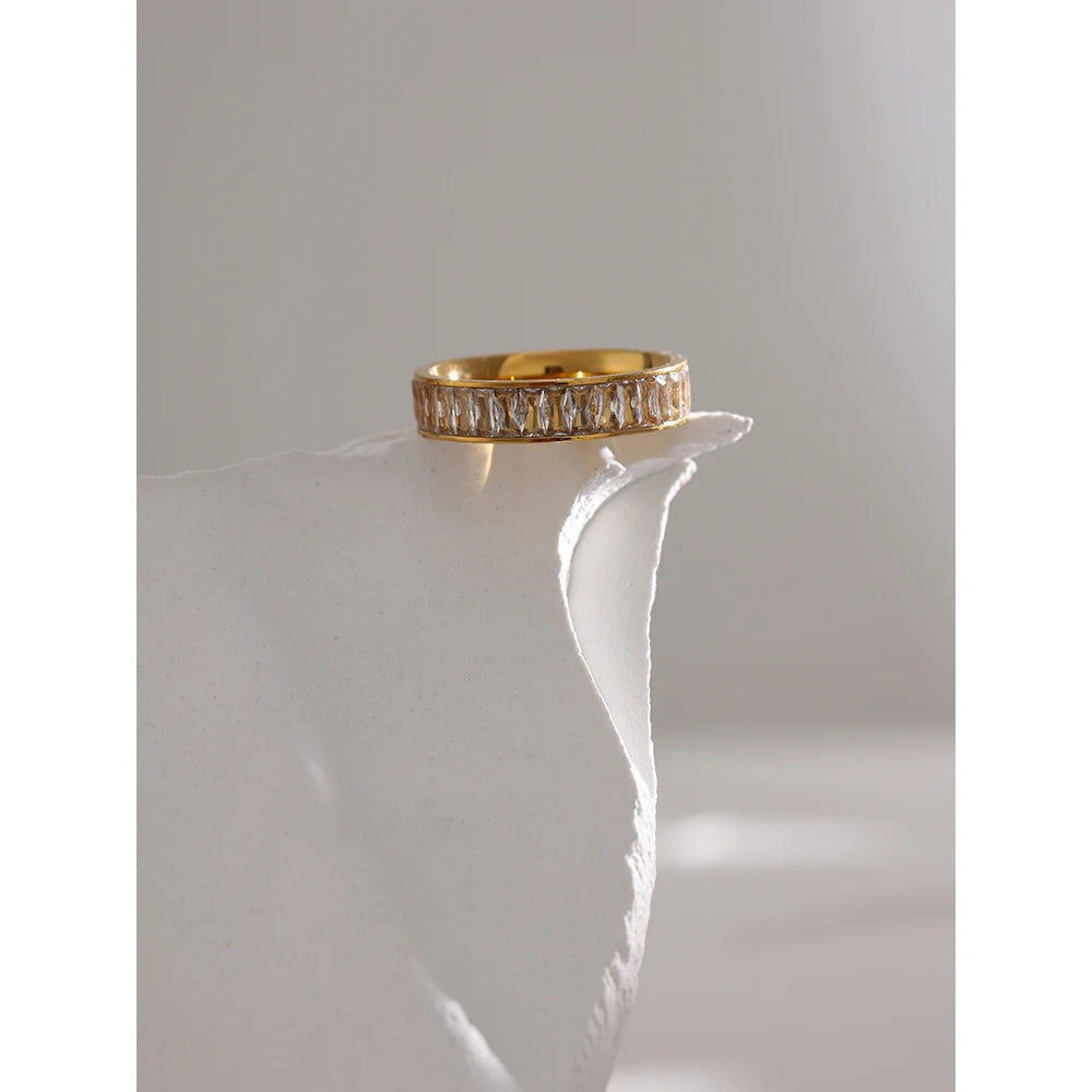 Cubic zirconia geometric ring in 18K gold-plated stainless steel with cubic zirconia.