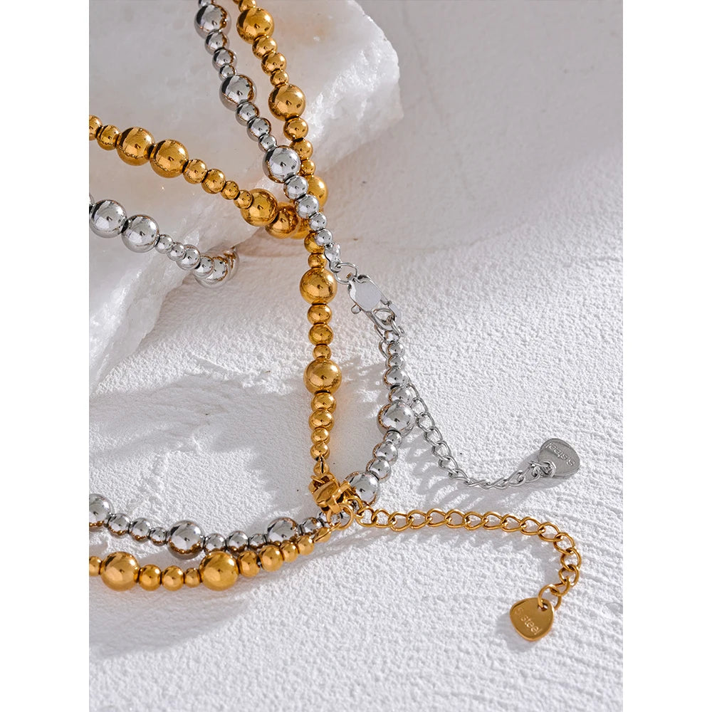 Beaded geometric chain necklace in gold-plated stainless steel.