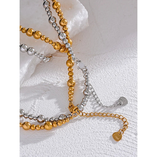 Beaded geometric chain necklace in gold-plated stainless steel.