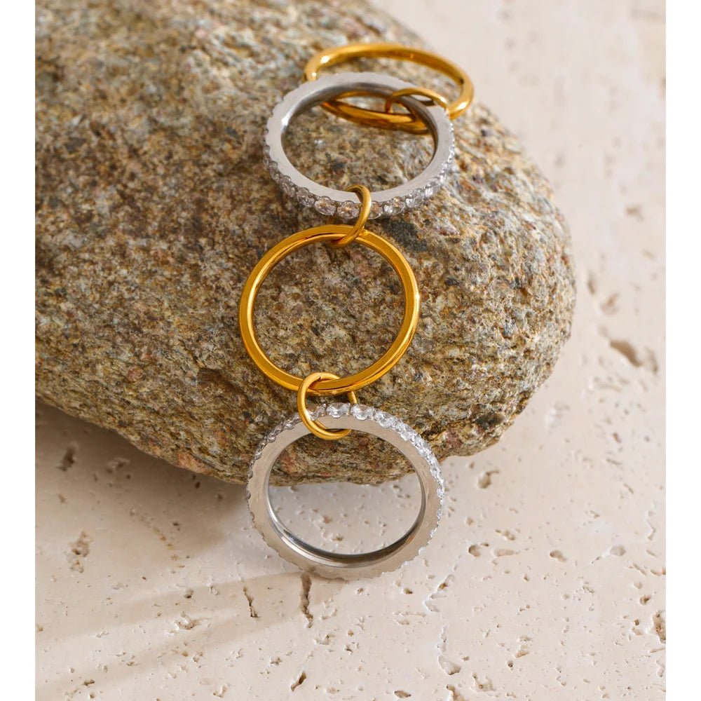 Cubic zirconia geometric layered ring in 18K gold-plated stainless steel with cubic zirconia.
