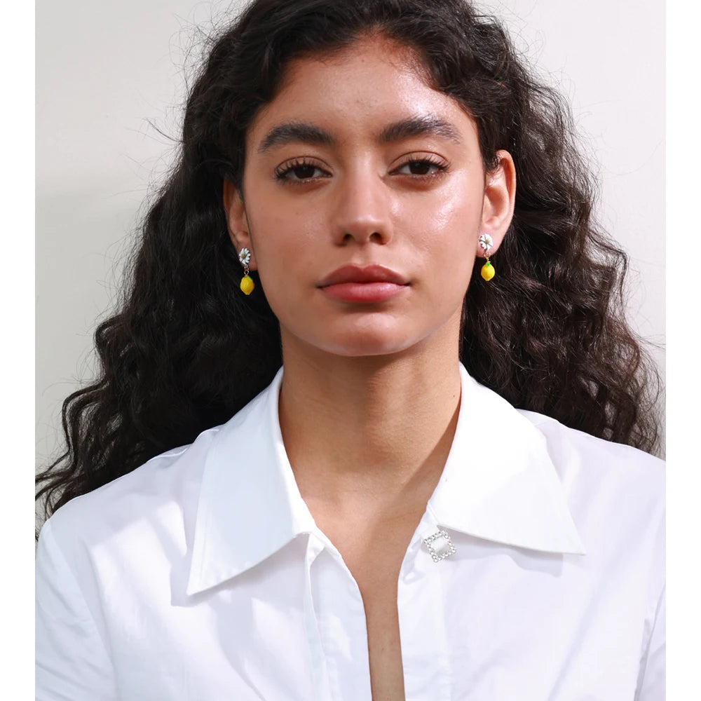 Cubic zirconia resin geometric earrings in gold-plated stainless steel with cubic zirconia and resin.