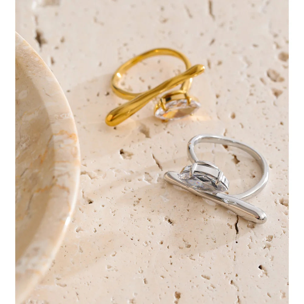 Cubic zirconia geometric ring in 18K gold-plated stainless steel with cubic zirconia.