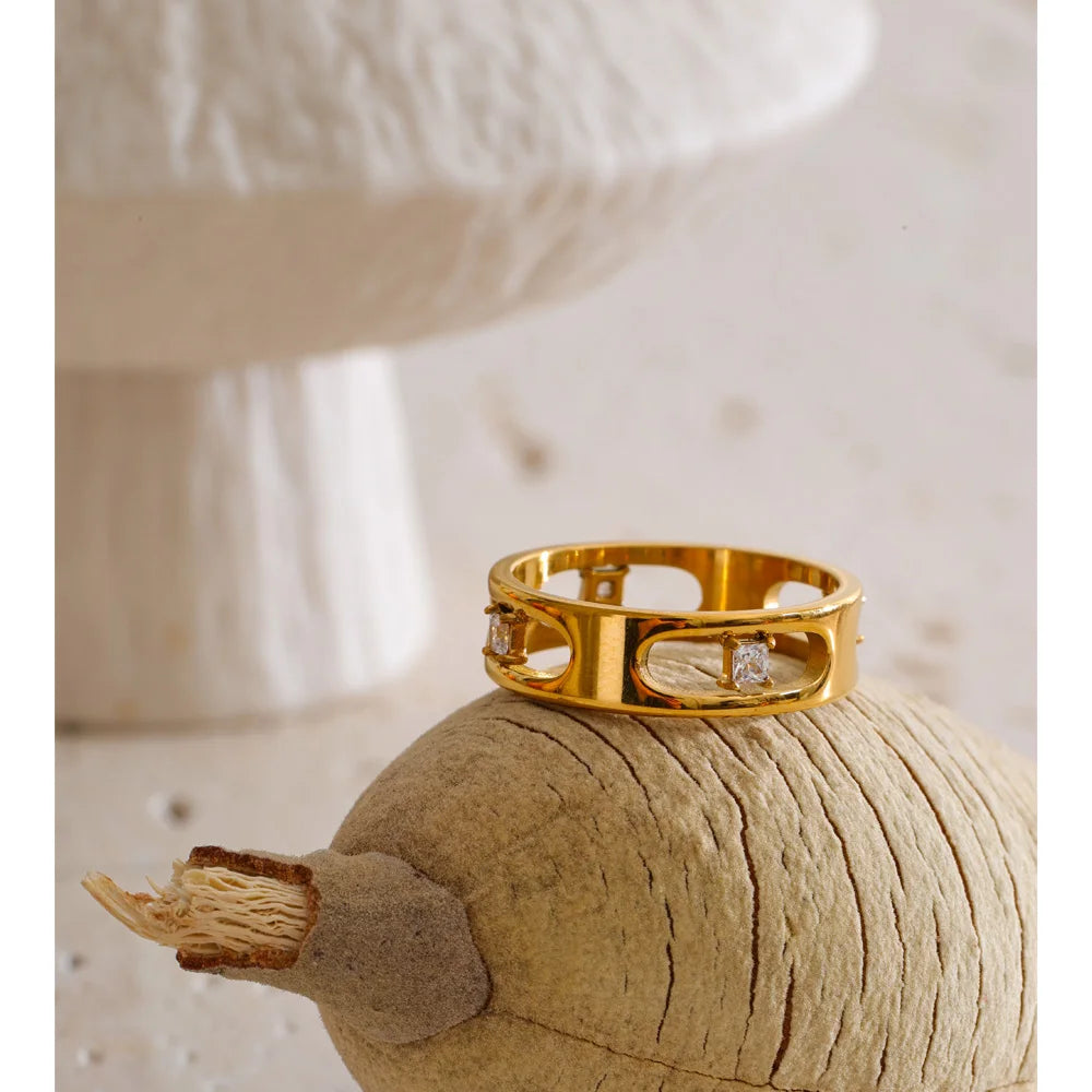Cubic zirconia geometric ring in 18K gold-plated stainless steel with cubic zirconia.