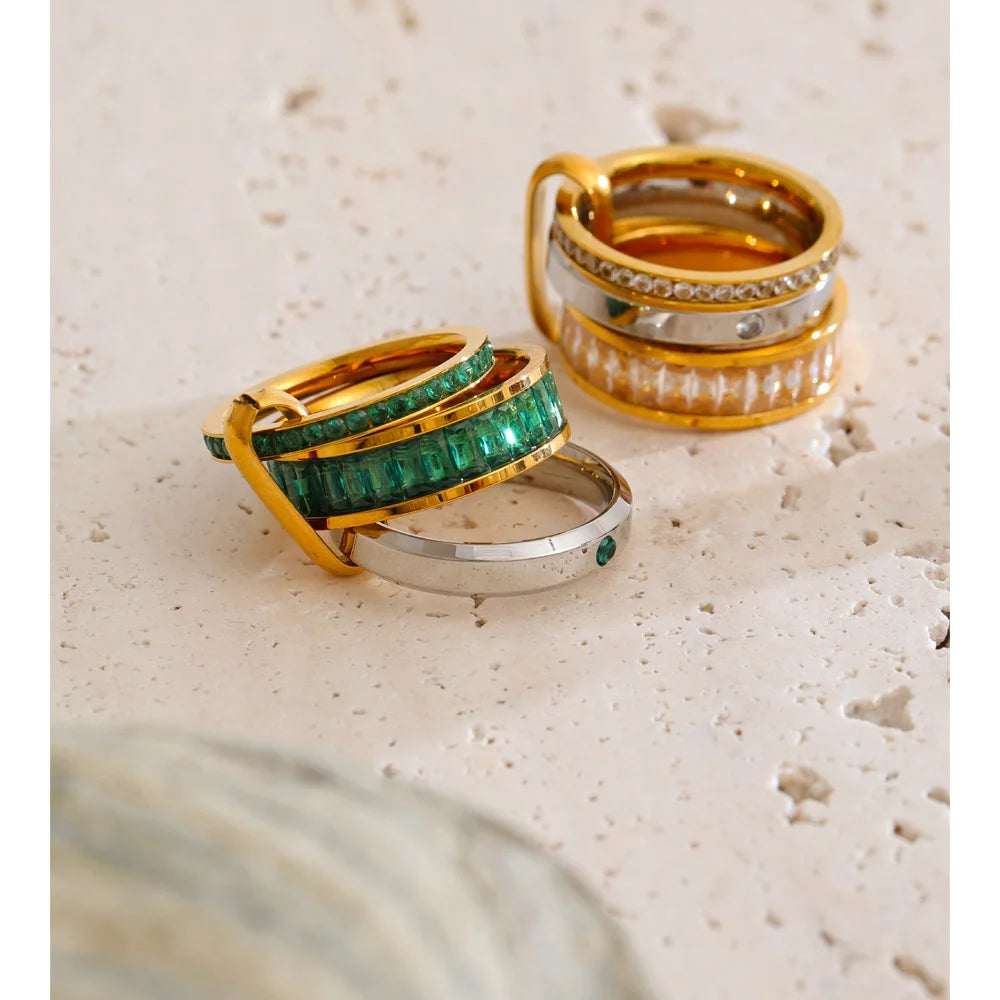 Cubic zirconia geometric layered ring in 18K gold-plated stainless steel with cubic zirconia.