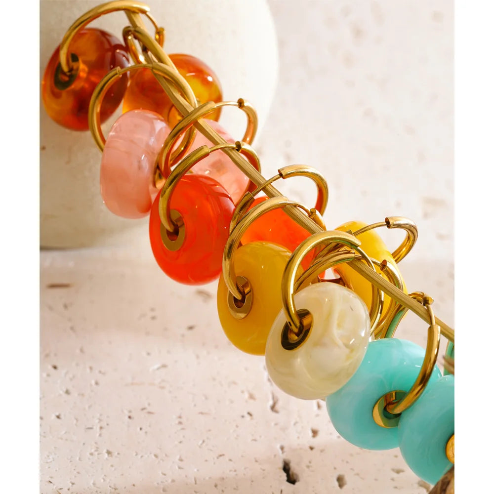 Resin acrylic geometric earrings in gold-plated stainless steel with resin and acrylic.