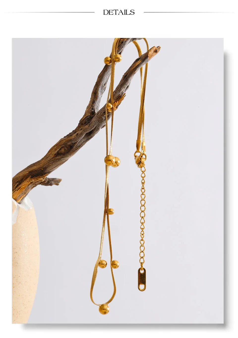 Beaded geometric chain necklace in gold-plated stainless steel.