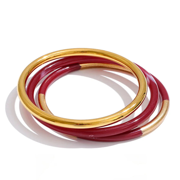 Gold-plated stainless steel bracelet with red resin.