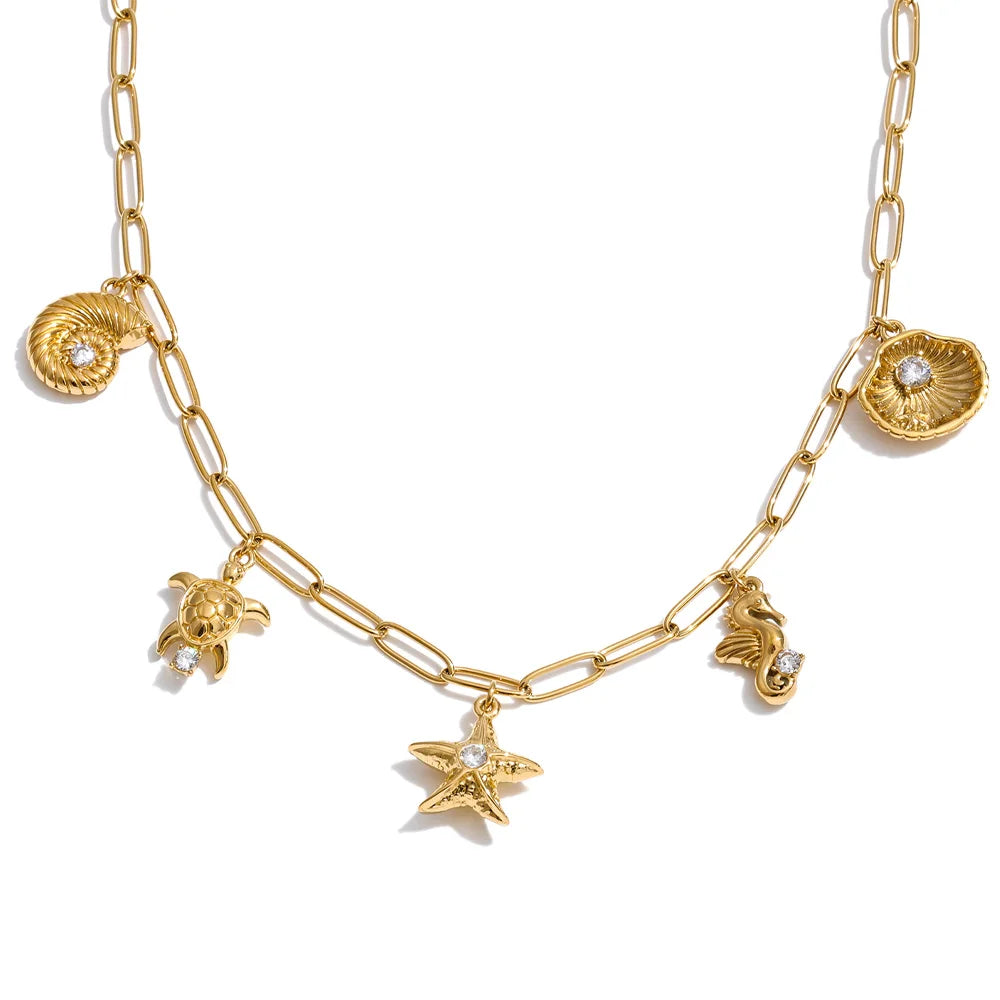 Cubic zirconia shell star necklace in gold-plated stainless steel with cubic zirconia and shell.