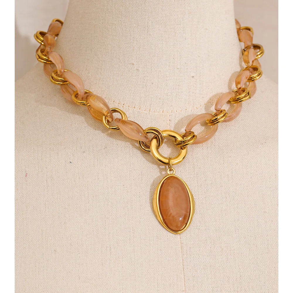 Resin acrylic geometric necklace in gold-plated stainless steel with resin and acrylic.