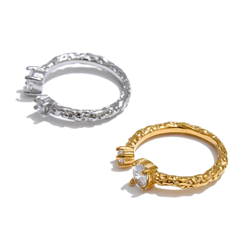 Cubic zirconia geometric ring in 18K gold-plated stainless steel with cubic zirconia.