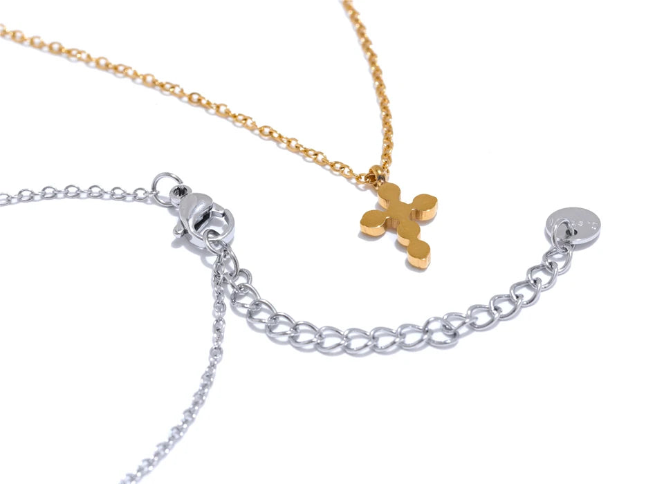 Cubic zirconia cross geometric necklace in gold-plated stainless steel with cubic zirconia.