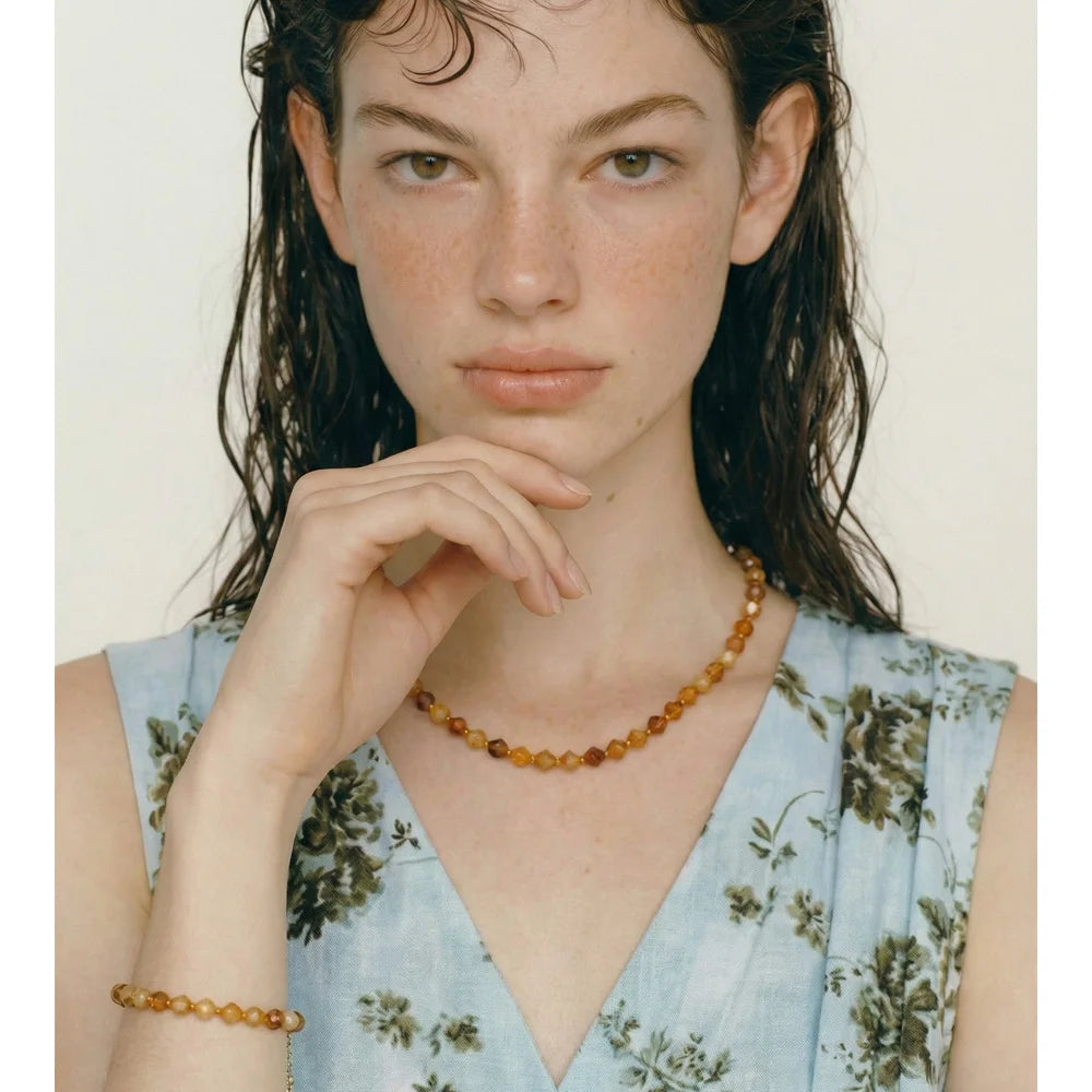 Natural stone beaded multi-color necklace in gold-plated stainless steel with natural stone.