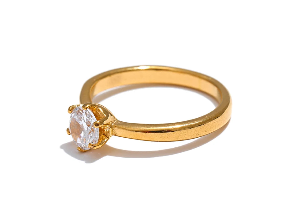 Cubic zirconia geometric ring in 18K gold-plated stainless steel with cubic zirconia.