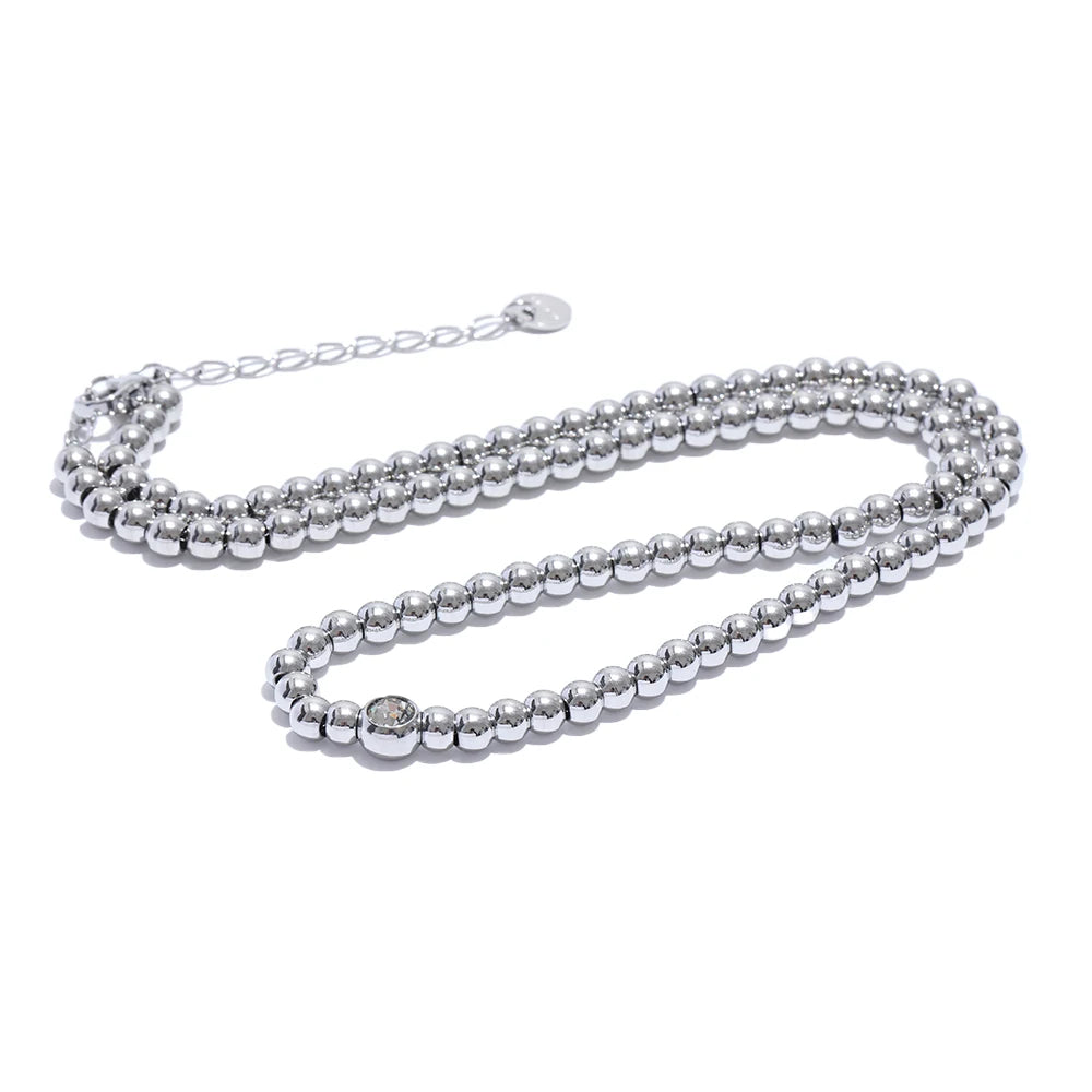 Cubic zirconia beaded geometric necklace in 18K gold-plated stainless steel with cubic zirconia.