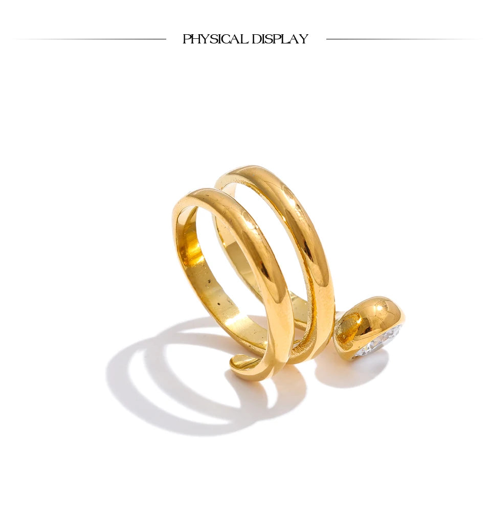 Cubic zirconia geometric layered ring in 18K gold-plated stainless steel with cubic zirconia.