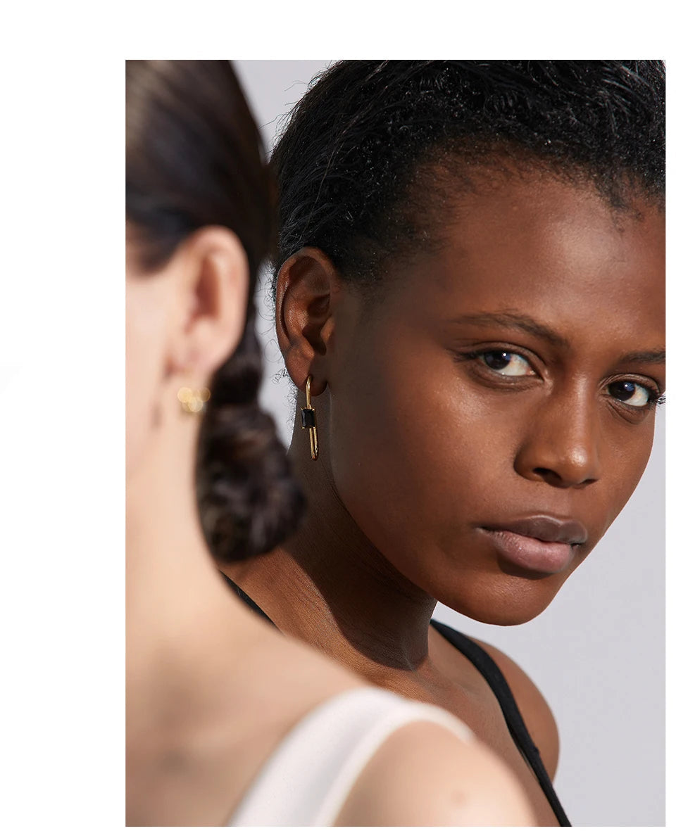 Black cubic zirconia geometric earrings in 18K gold-plated stainless steel with cubic zirconia.