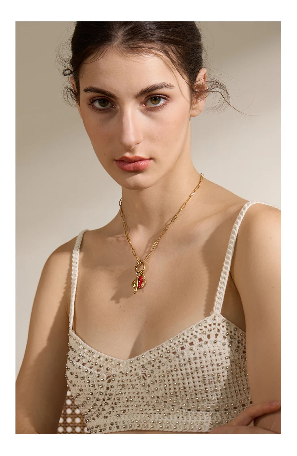 Red heart geometric necklace in gold-plated 316L stainless steel.