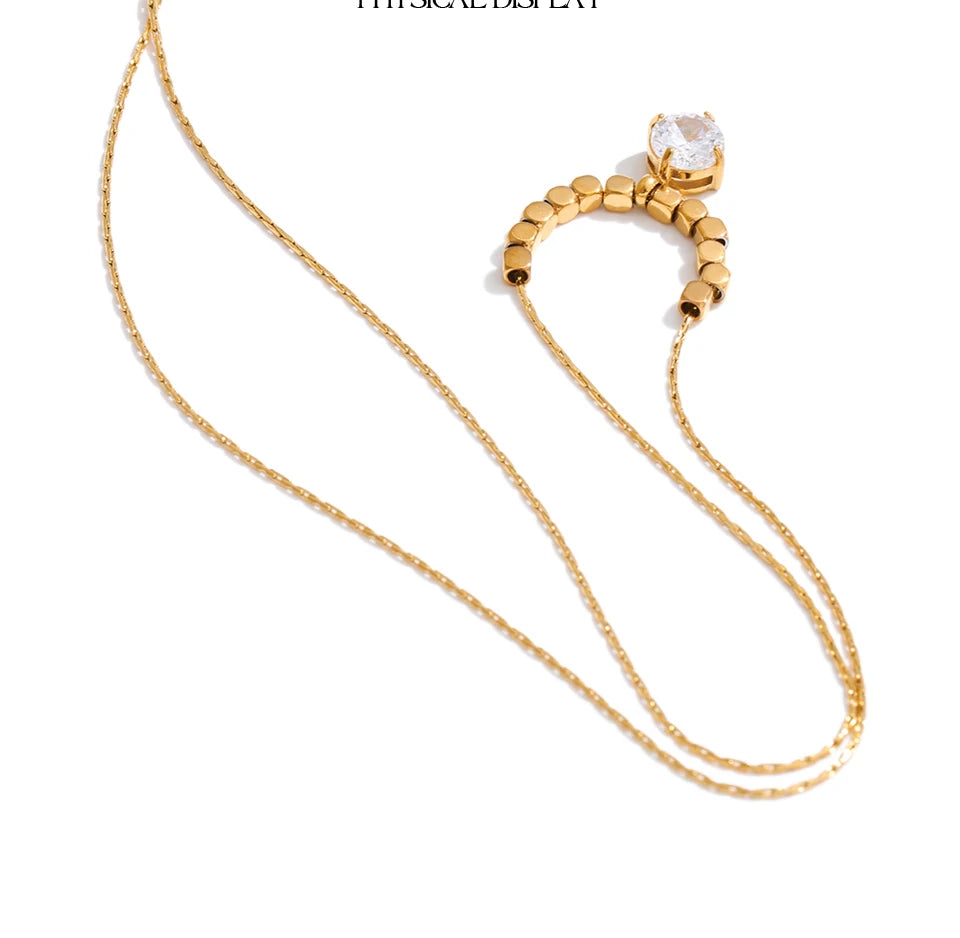 Cubic zirconia beaded geometric necklace in gold-plated stainless steel with cubic zirconia.