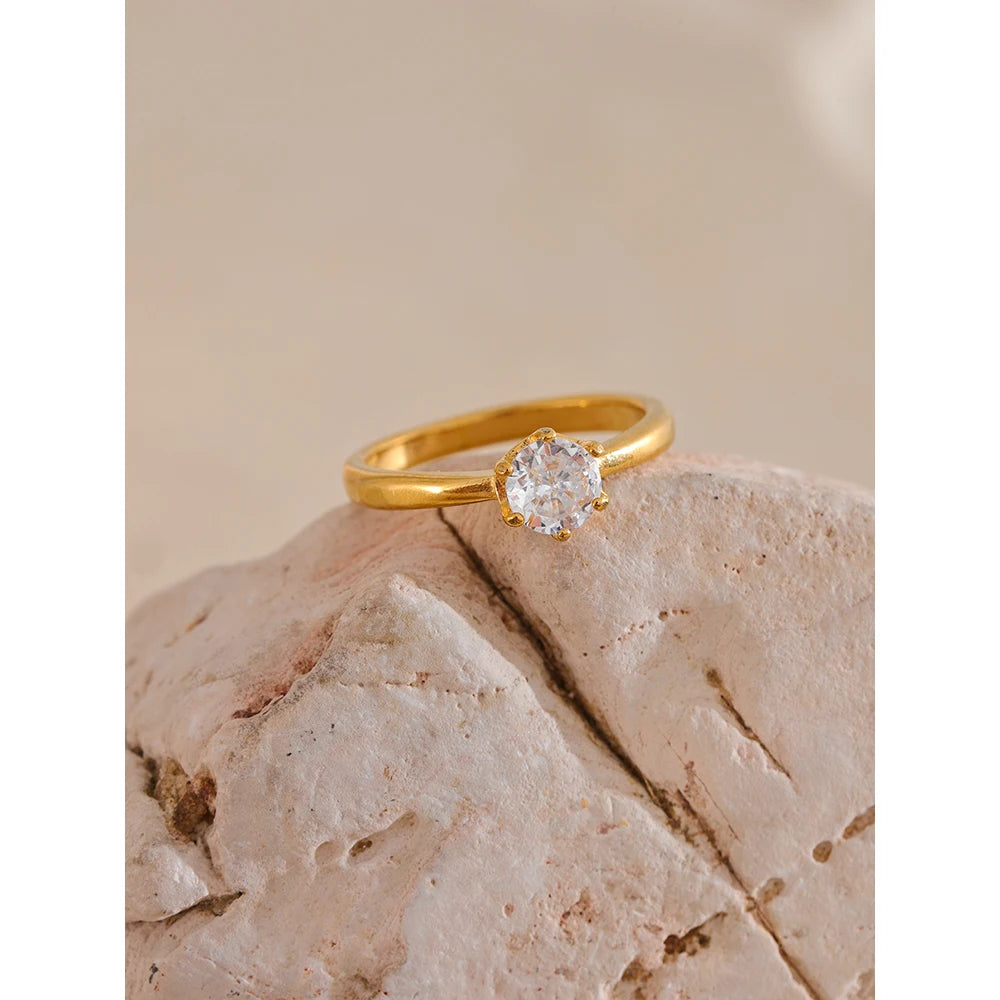 Cubic zirconia geometric ring in 18K gold-plated stainless steel with cubic zirconia.