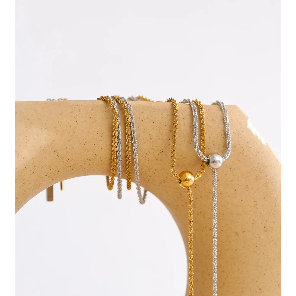 Beaded geometric chain necklace in gold-plated stainless steel.