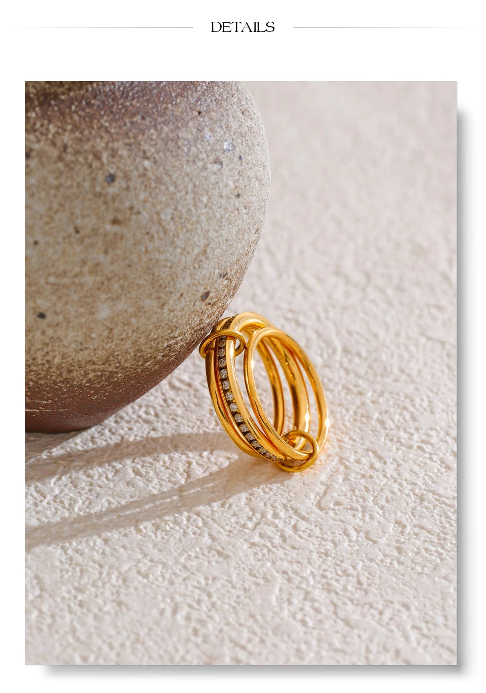 Cubic zirconia geometric layered ring in 18K gold-plated stainless steel with cubic zirconia.