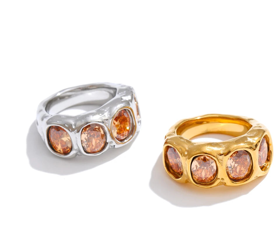 Cubic zirconia geometric ring in 18K gold-plated stainless steel with cubic zirconia.