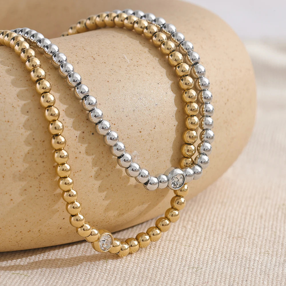 Cubic zirconia beaded geometric necklace in 18K gold-plated stainless steel with cubic zirconia.