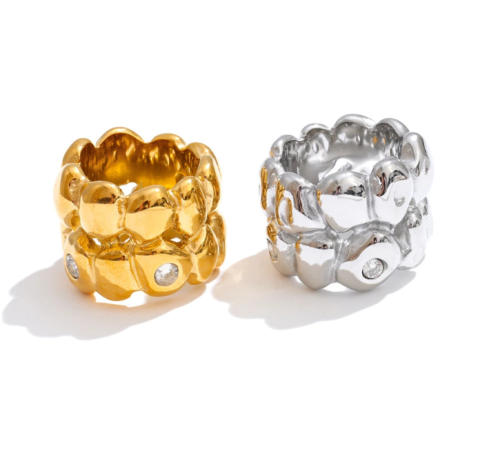 Cubic zirconia geometric ring in 18K gold-plated stainless steel with cubic zirconia.