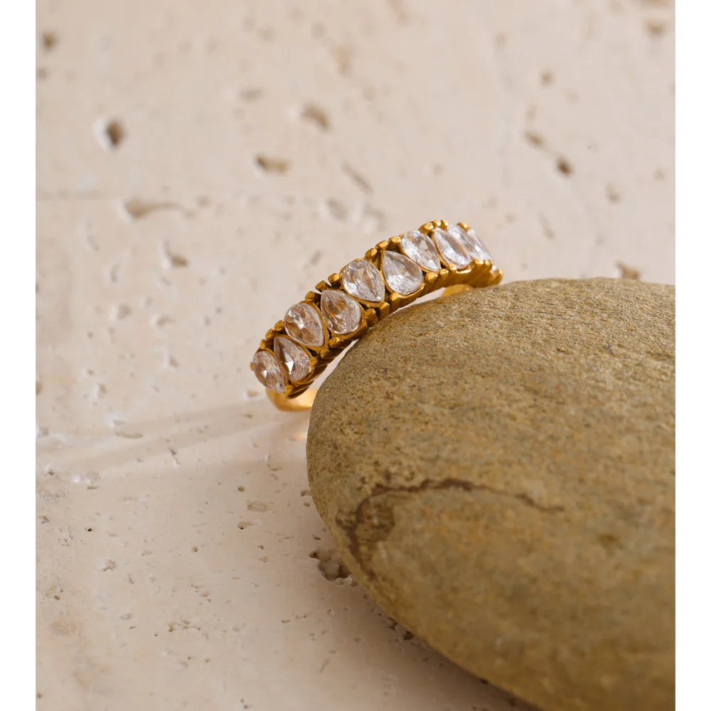 Cubic zirconia geometric ring in 18K gold-plated stainless steel with cubic zirconia.