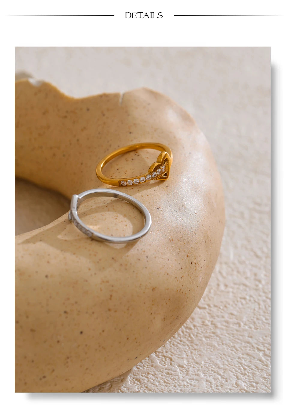 Cubic zirconia heart cross ring in 18K gold-plated stainless steel with cubic zirconia.