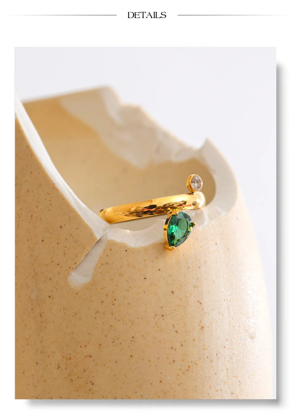 Green cubic zirconia geometric ring in 18K gold-plated stainless steel with cubic zirconia.
