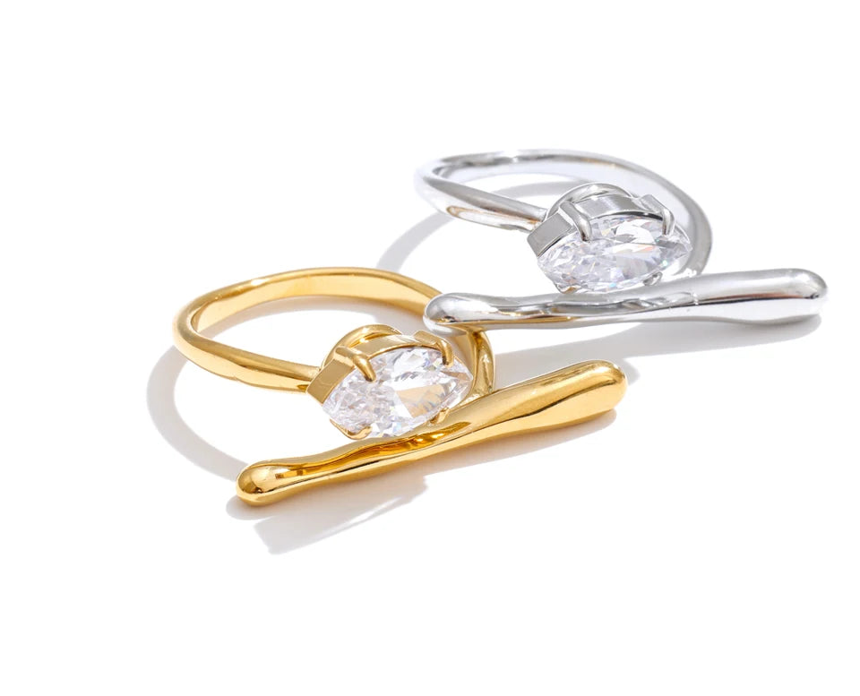 Cubic zirconia geometric ring in 18K gold-plated stainless steel with cubic zirconia.