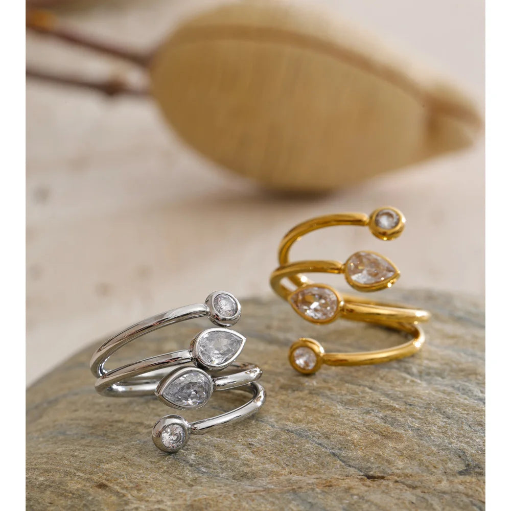 Cubic zirconia geometric layered ring in 18K gold-plated stainless steel with cubic zirconia.
