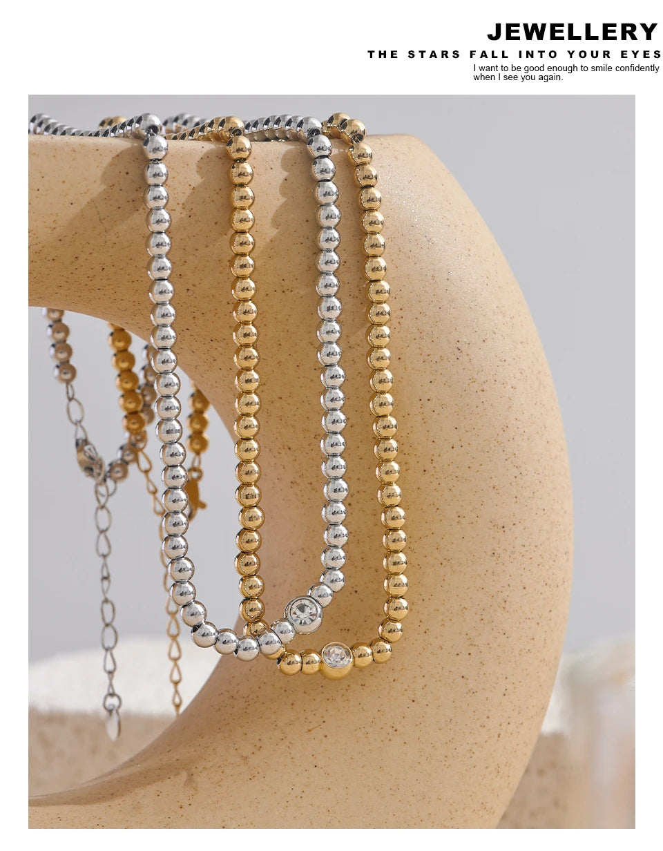 Cubic zirconia beaded geometric necklace in 18K gold-plated stainless steel with cubic zirconia.