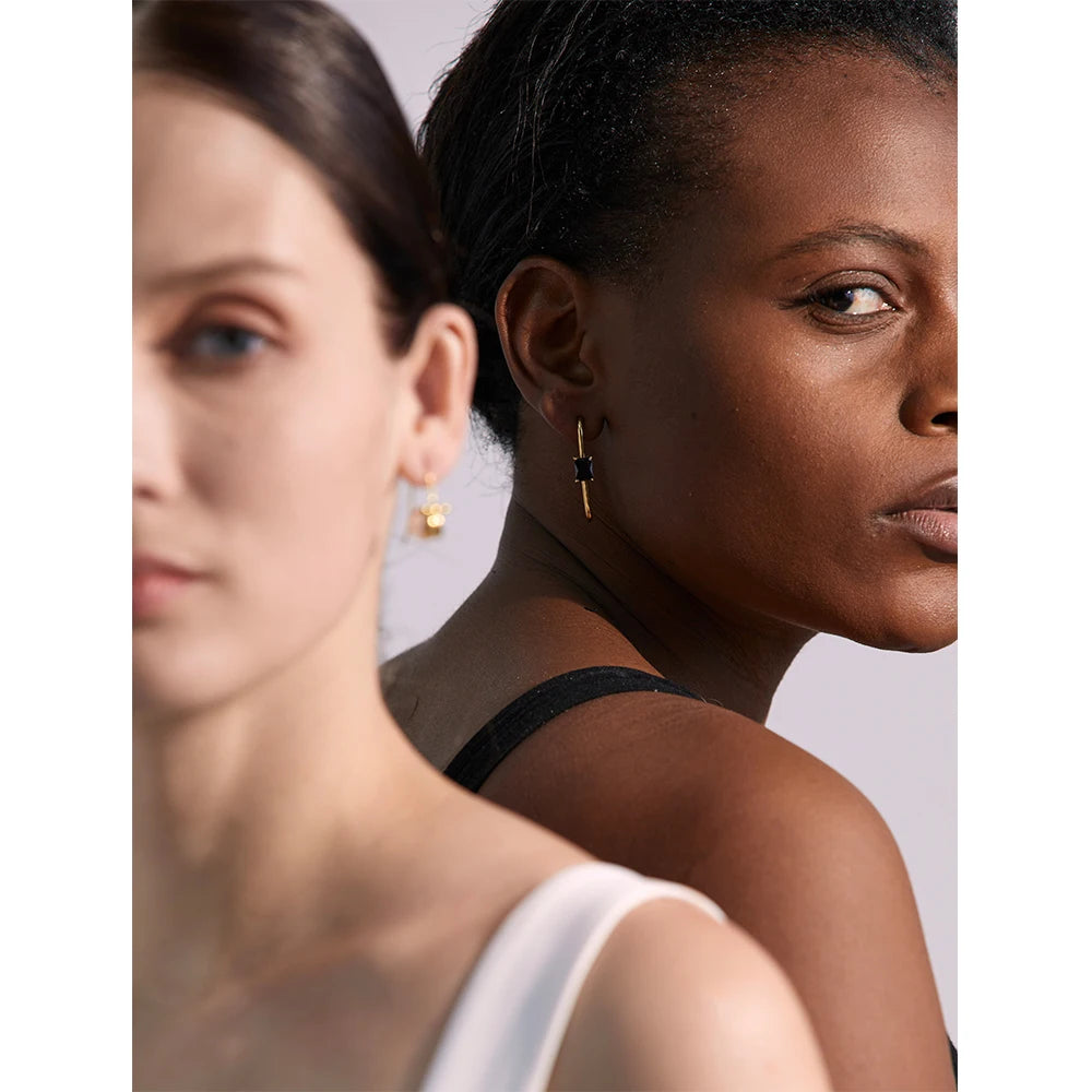 Black cubic zirconia geometric earrings in 18K gold-plated stainless steel with cubic zirconia.