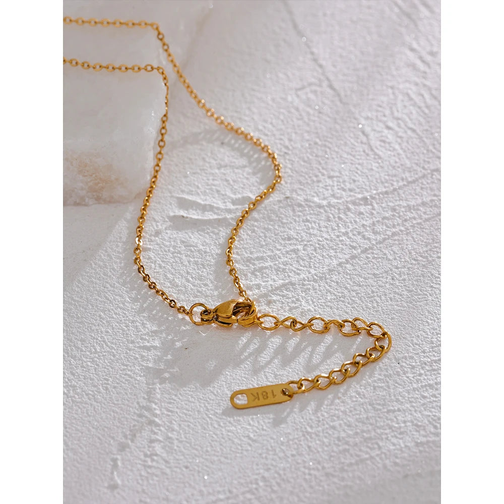 Cubic zirconia star moon necklace in gold-plated stainless steel with cubic zirconia.