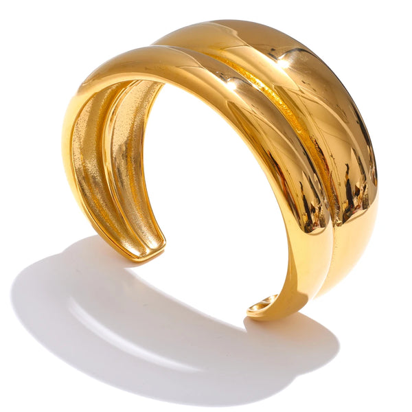 Gold-plated stainless steel bracelet with a large, twisted band.