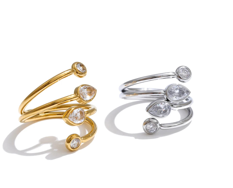 Cubic zirconia geometric layered ring in 18K gold-plated stainless steel with cubic zirconia.