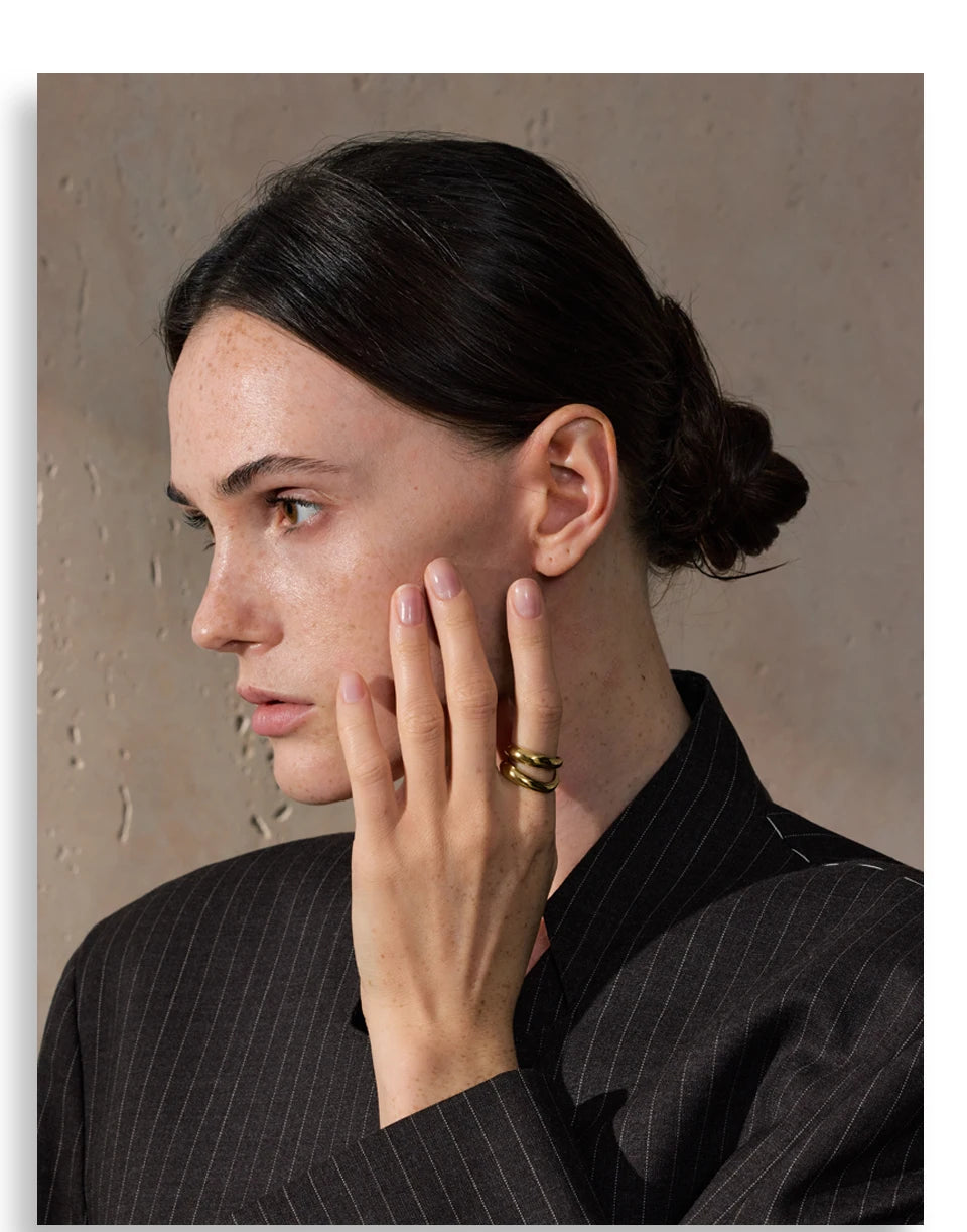 Geometric layered ring in gold-plated stainless steel.