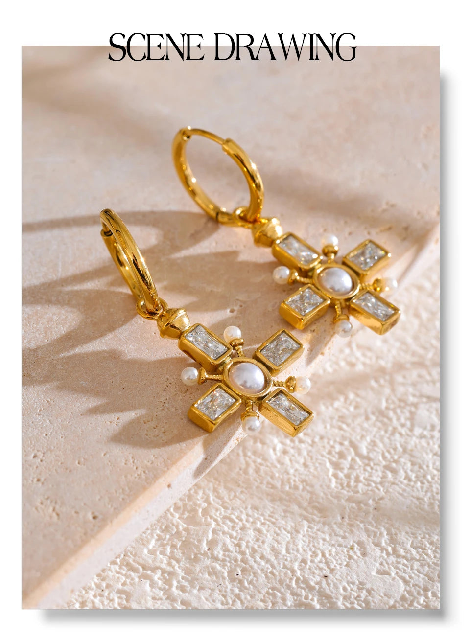 Cubic zirconia pearl cross earrings in gold-plated stainless steel with pearl and cubic zirconia.