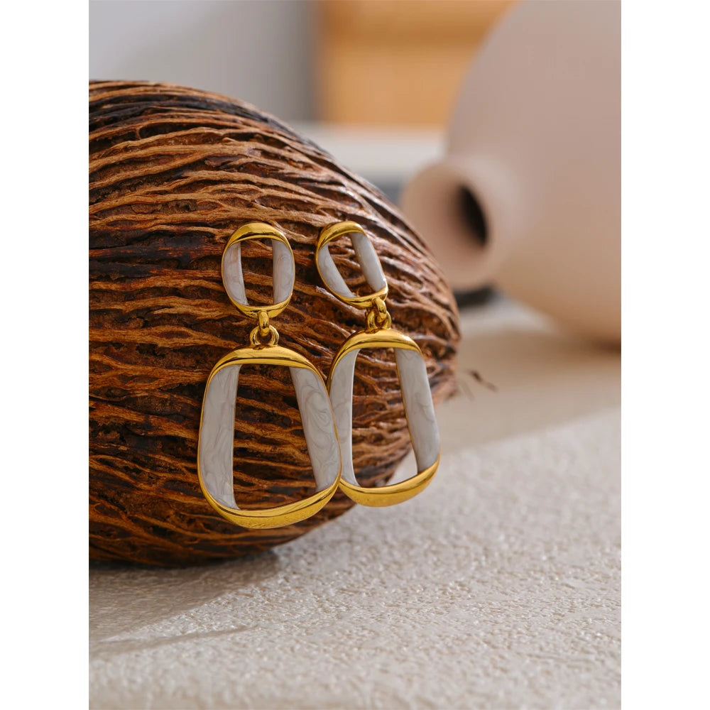 White enamel geometric earrings in gold-plated stainless steel with enamel.