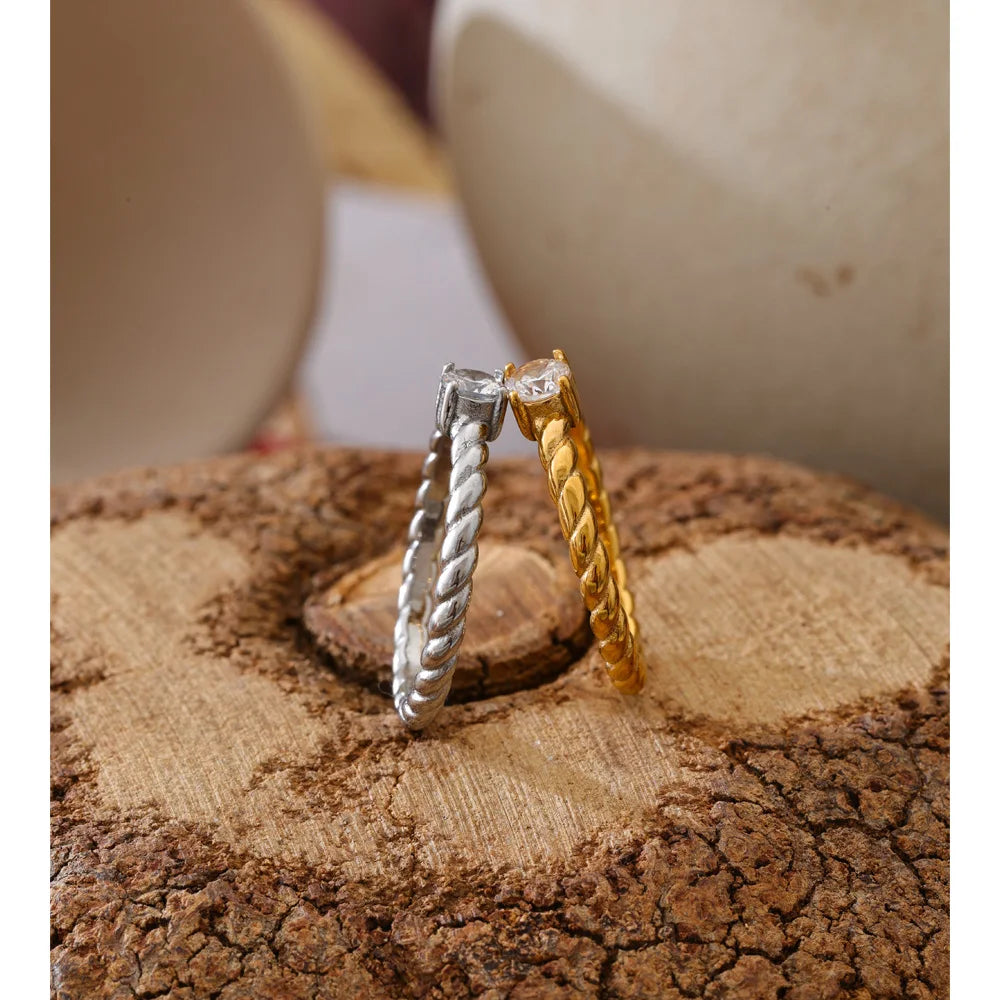 Cubic zirconia geometric ring in 18K gold-plated stainless steel with cubic zirconia.
