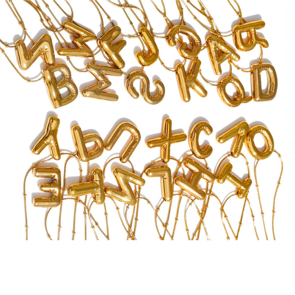 Gold-plated stainless steel necklace featuring a collection of letters and numbers in various fonts and sizes.