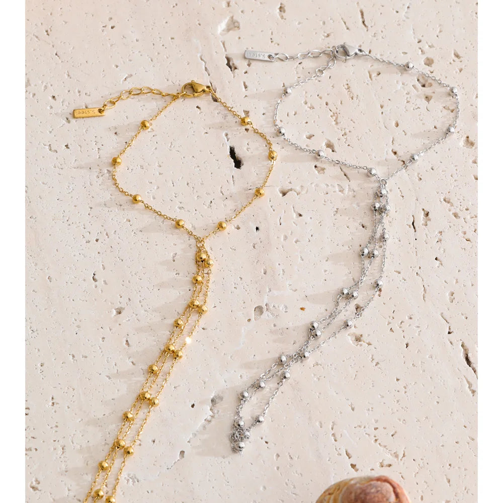Beaded geometric chain necklace in gold-plated stainless steel.