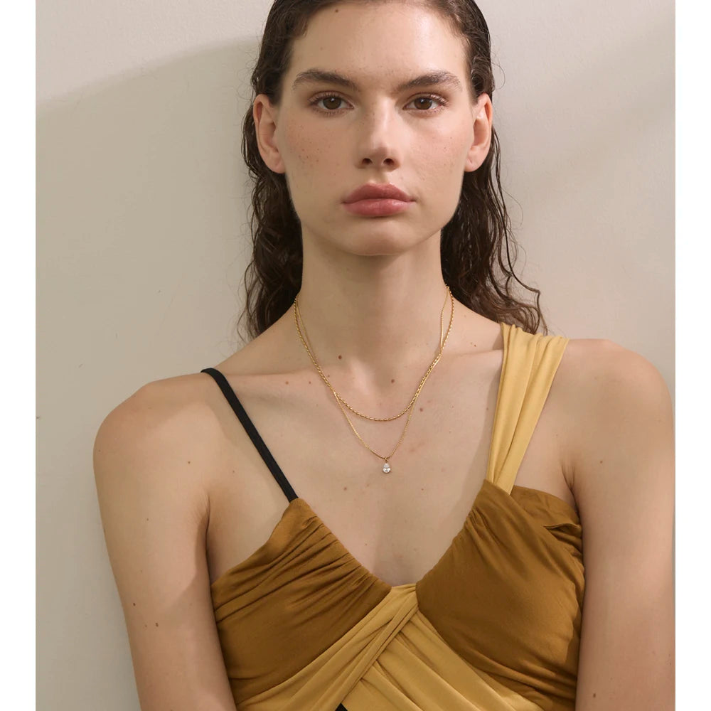 Cubic zirconia geometric layered necklace in gold-plated stainless steel with cubic zirconia.