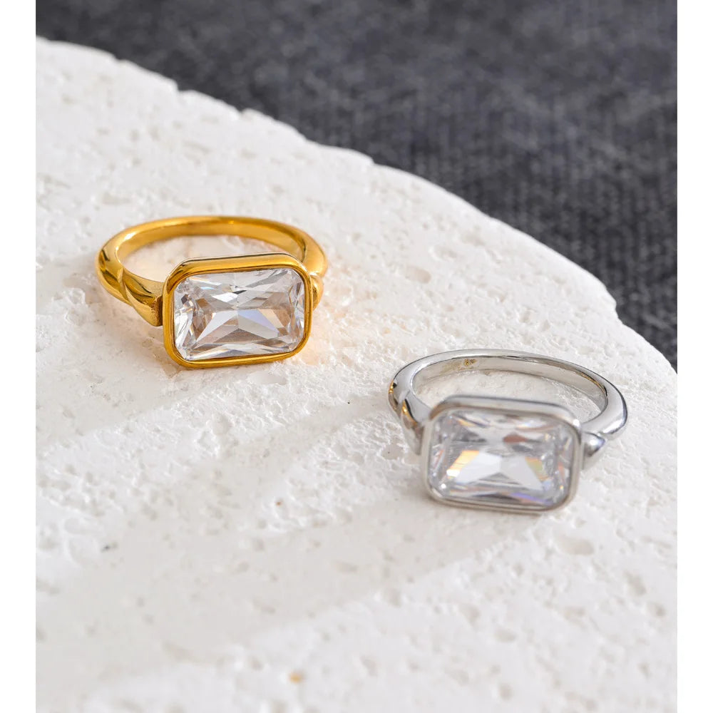 Cubic zirconia geometric ring in 18K gold-plated stainless steel with cubic zirconia.