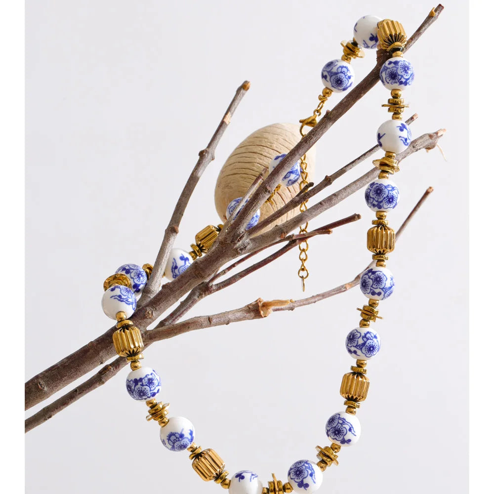 Blue flower beaded necklace in gold-plated stainless steel.