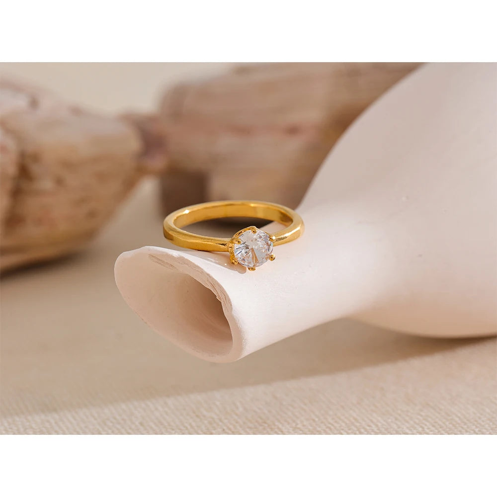Cubic zirconia geometric ring in 18K gold-plated stainless steel with cubic zirconia.