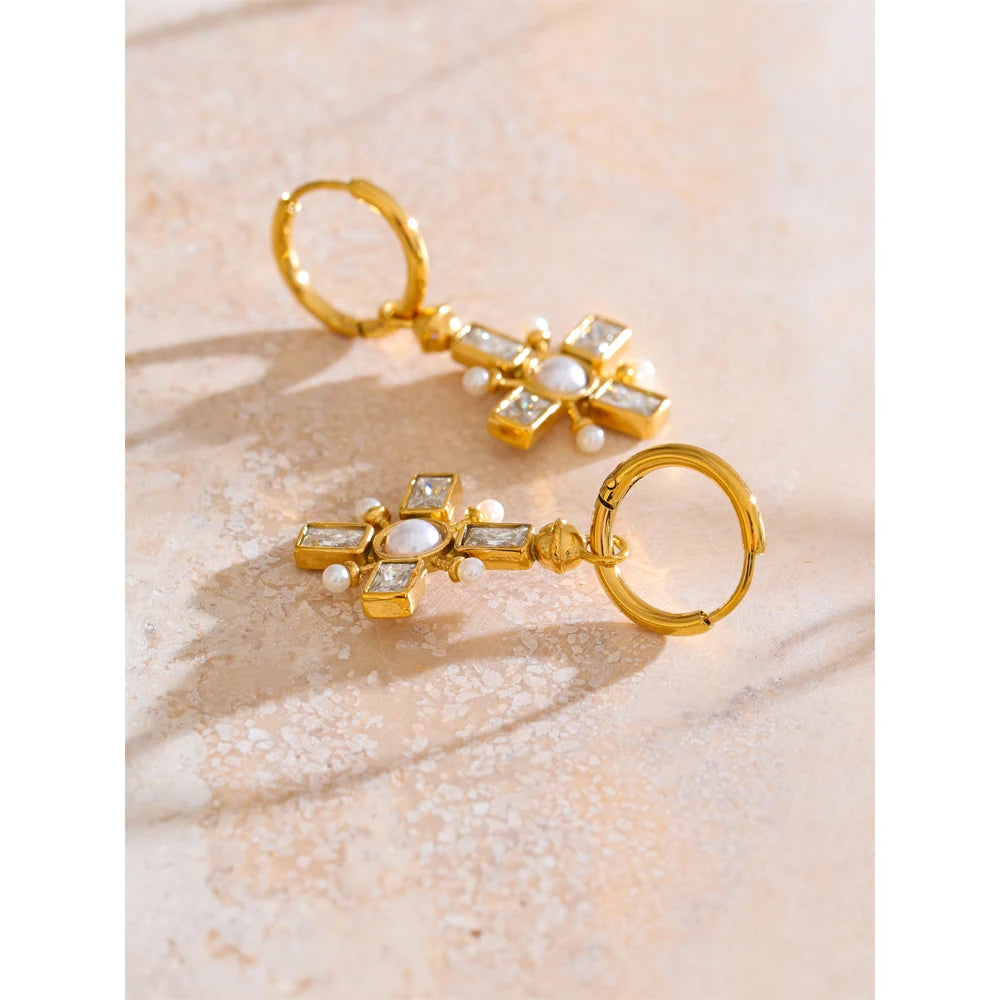 Cubic zirconia pearl cross earrings in gold-plated stainless steel with pearl and cubic zirconia.