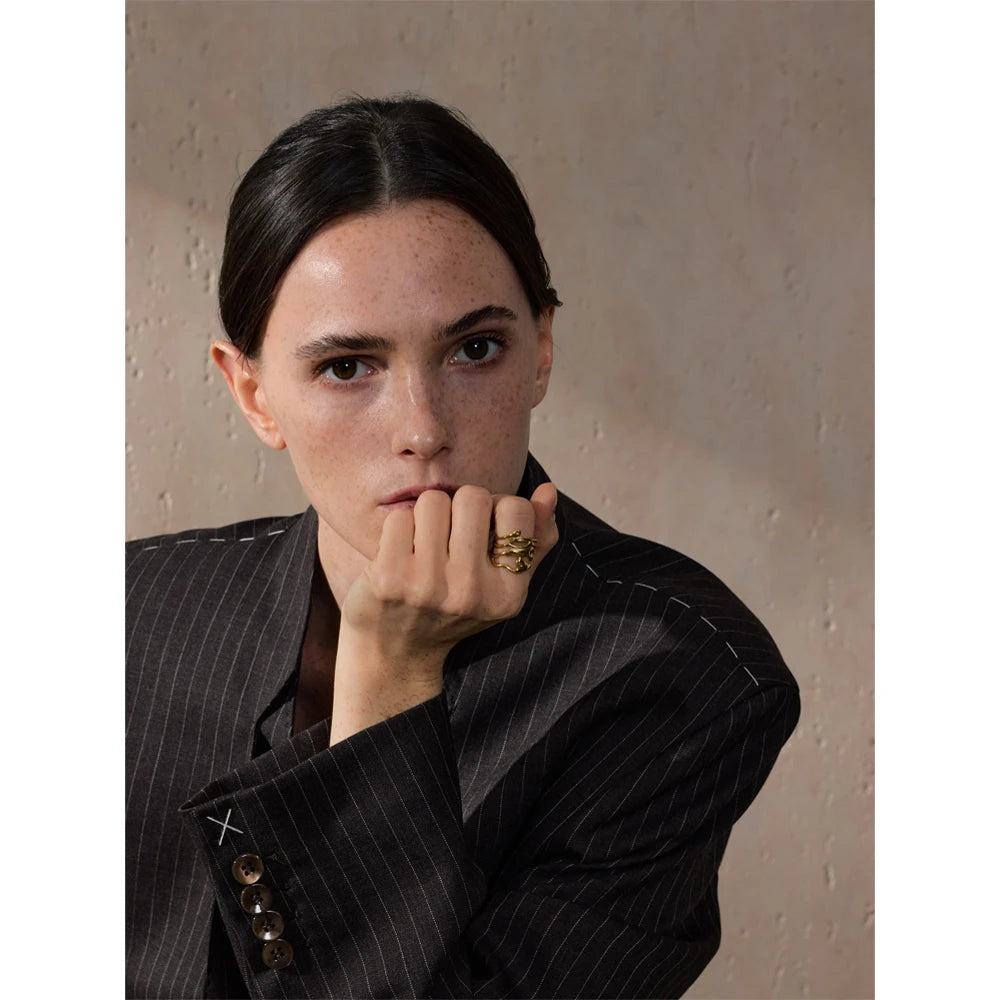 Geometric layered ring in gold-plated 316L stainless steel.